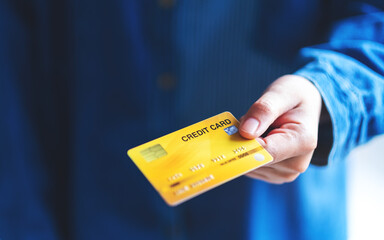 Closeup image of a woman holding and showing credit card
