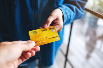 People holding and giving a credit card to someone