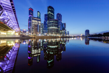 View of modern office buildings on the river bank, long exposure.