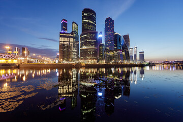 View of modern office buildings on the river bank, long exposure.