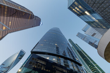 Fototapeta na wymiar Modern office buildings in the financial district, view up. Dark, stormy sky.