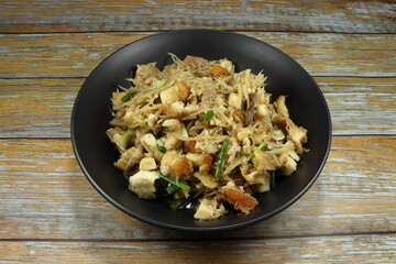 Fried chopped fish meat with sliced ginger and spring onion on the plate. Famous side dish menu in Asia restaurant.