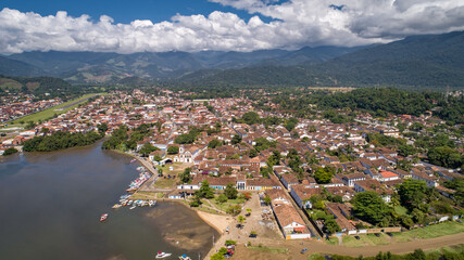 Aerial view to historic town Paraty and harbour, green mountains  with white clouds in background, sunny day, Unesco World Heritage, Brazil