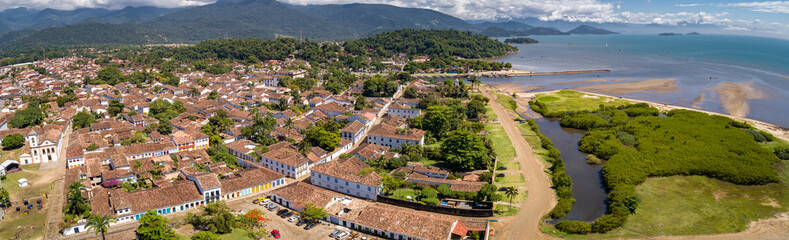 Fototapeta na wymiar Aerial view panorama of historic town Paraty with green mountains and sea in background on a sunny day, Unesco World Heritage, Brazil