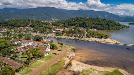 Fototapeta na wymiar Aerial view to historic town Paraty, tidal river and Jabaquara with green mountains in background on a sunny day, Brazil, Unesco World Heritage