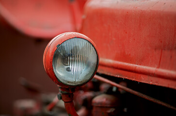 close up of a red headlight on an old tractor