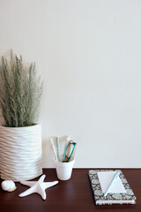 Wall mockup with beach/ocean theme decorations on wooden surface. Copy space.