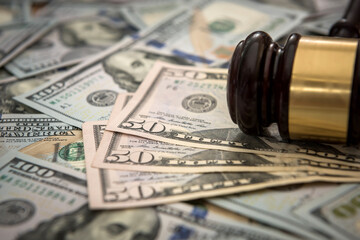 justice gavel on dollar banknotes