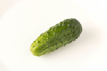Fresh green cucumber on a light background. The concept of natural food. Selective focus.