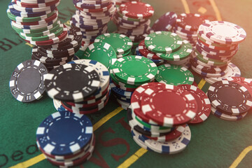 Casino poker chips on green felt background. All for success game