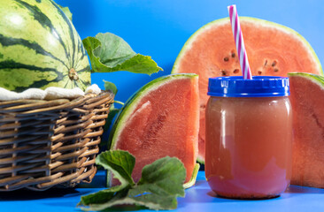 Watermelon juice and fresh fruits on blue background - obrazy, fototapety, plakaty