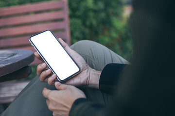 cell phone mockup image blank white screen.woman hand holding texting using mobile on desk at coffee shop.background empty space for advertise.work people contact marketing business,technology