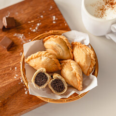Chocolate inside Puff pestry and coffee cup on a wooden cutting board and ingredients