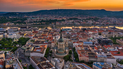Fototapeta na wymiar Budapest, Hungary - Aerial panoramic view of Budapest with a magnificent golden sunset. The view includes St.Stephen's Basilica, Szechenyi Chain Bridge and ferris wheel at Elisabeth Square at summer