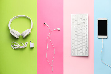 Different modern devices on color background