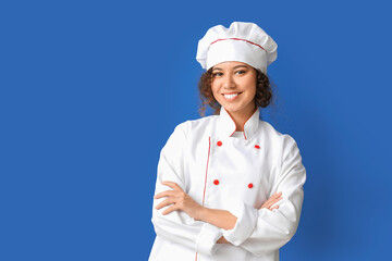 Female African-American chef on color background