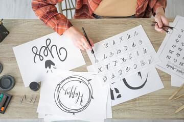 Female calligraphist working in office