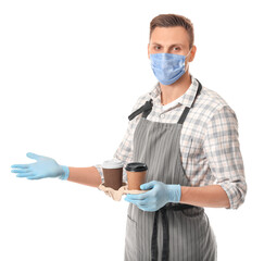 Fototapeta na wymiar Young male barista in mask on white background. Concept of epidemic