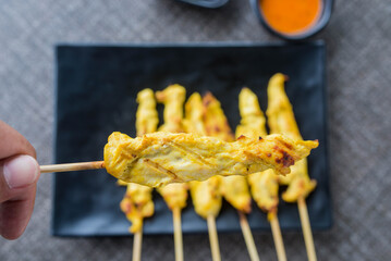 satay chicken on top view and black plate for advertisement
