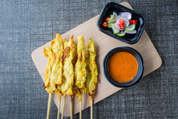 satay chicken on top view and black plate for advertisement