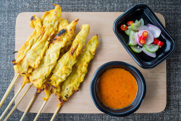 satay chicken on top view and black plate for advertisement