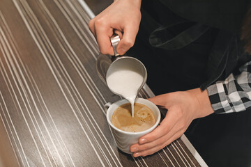 Fototapeta na wymiar Young barista making coffee in cafe, closeup
