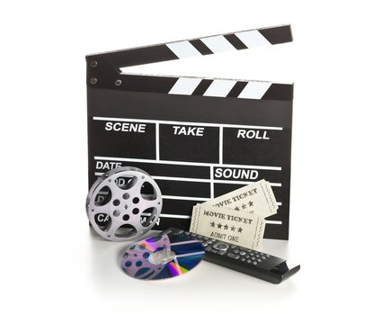 Single, black, open movie clapper or clapper-board with dvd movie disc, film reel, remote control and movie theatre tickets on white - digital movie, home cinema or movie night concept