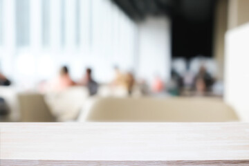 Empty wooden desk space and blurry background of cafe or Restaurant for product display montage.
