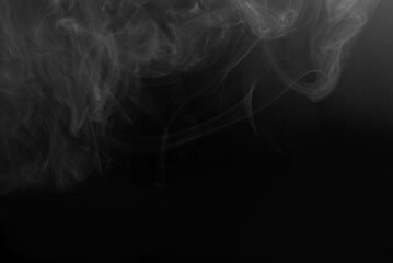 White smoke on a black background. The texture of scattered smoke. Blank for design. Layout for collages.