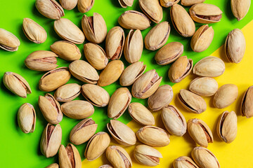 roasted salted pistachios nuts on a colored background close-up