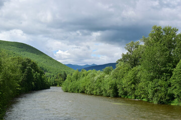 Fototapeta na wymiar Taiga river among blue-green mountains. Sikhote-Alin.