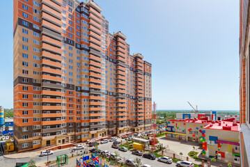 A multi-storey residential building with a building of a kindergarten in front of it. Rostov-on-Don / Russia - 07 may 2019