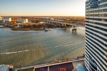 The window view on a river and a road bridge from new modern residential building at the evening time. Don river, Rostov-on-Don, Russia