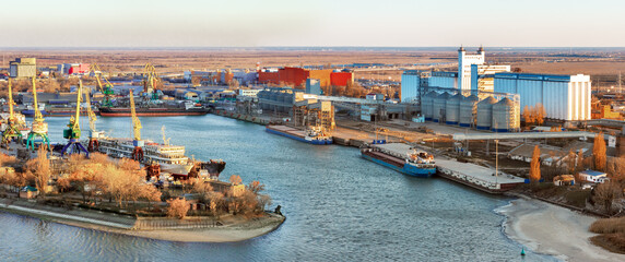 The panoramic view the river harbor with the big industrial building of grain elevator and  a cargo...