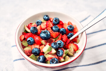 Fresh Fruit Salad in the bowl. Fig strawberry blueberry fruit salad, concept diet and healthy eating