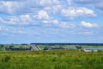 Fototapeta na wymiar Polish summer landscape with expressway S7 or express road S7, near the city of Kielce. Poland