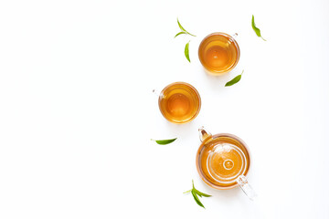 Black tea, green tea in a glass teapot with tea leaves.