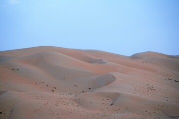 sand dunes in the liwa desert by blue sky