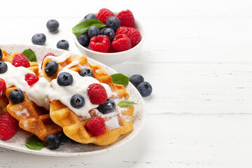 Fototapeta na wymiar Delicious belgian waffles with summer berries