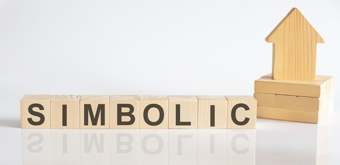 SIMBOLIC -Wooden Blocks With A Miniature House on white background