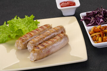 Grilled sausages served mushrooms and cabbage