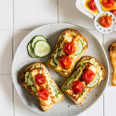 Avocado, Fried Cheese, Cucumber and Tomato Toasts