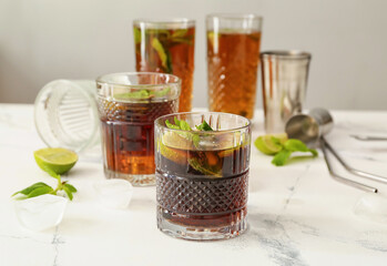 Glasses of tasty Cuba Libre cocktail on table