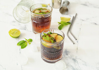 Glasses of tasty Cuba Libre cocktail on table