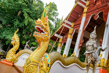 Fototapeta na wymiar Buddhist temple with dragons and harpies at the entrance. Chiang Mai, Thailand - 