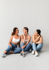 Obraz premium Women of different nationalities on light background. Stop racism