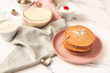 Tasty pancakes with ingredients on white background