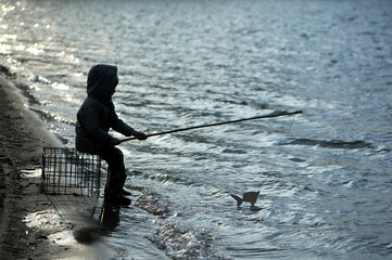 The little boy is fishing.