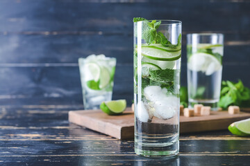 Glass of fresh mojito on table