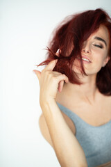 Beautiful young ginger woman with blue eyes. Portrait of charming girl wearing casual clothes...